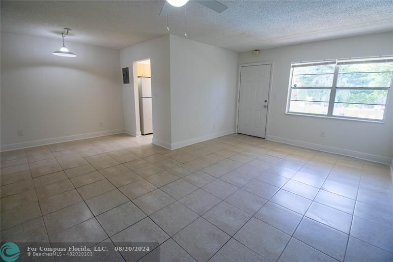 an empty room with white walls and tiles