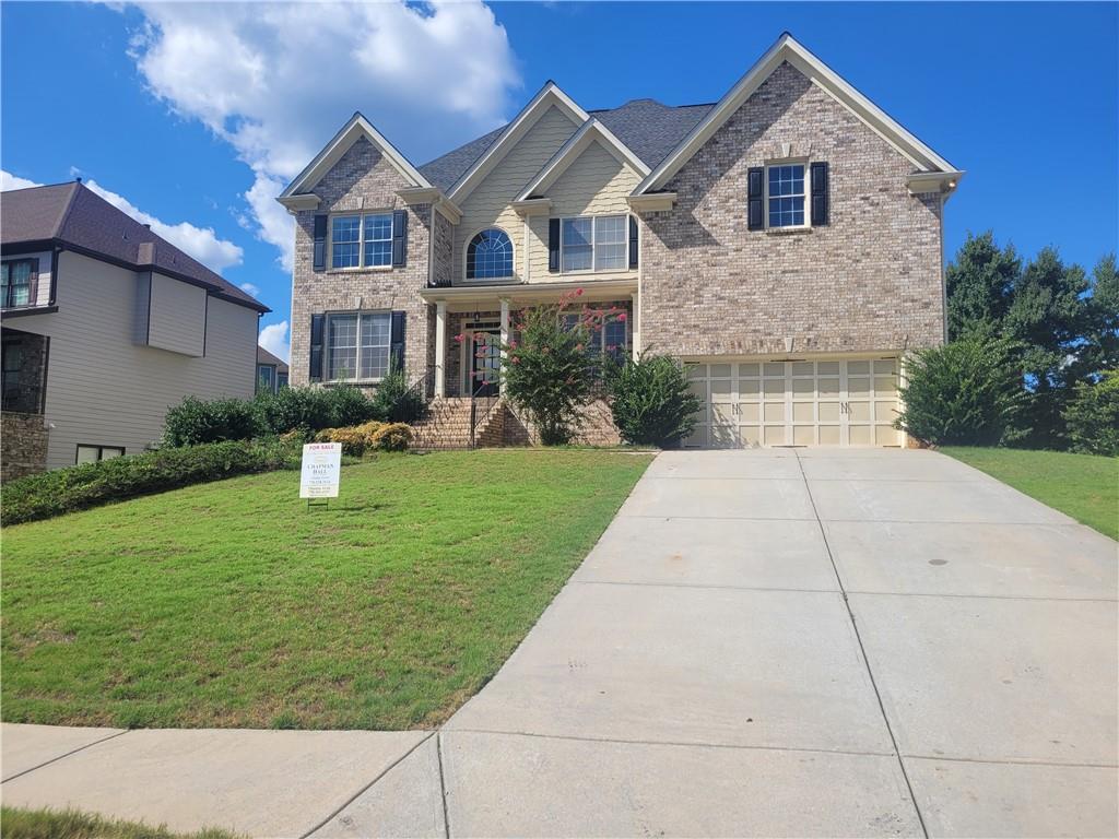 a front view of house with yard and green space