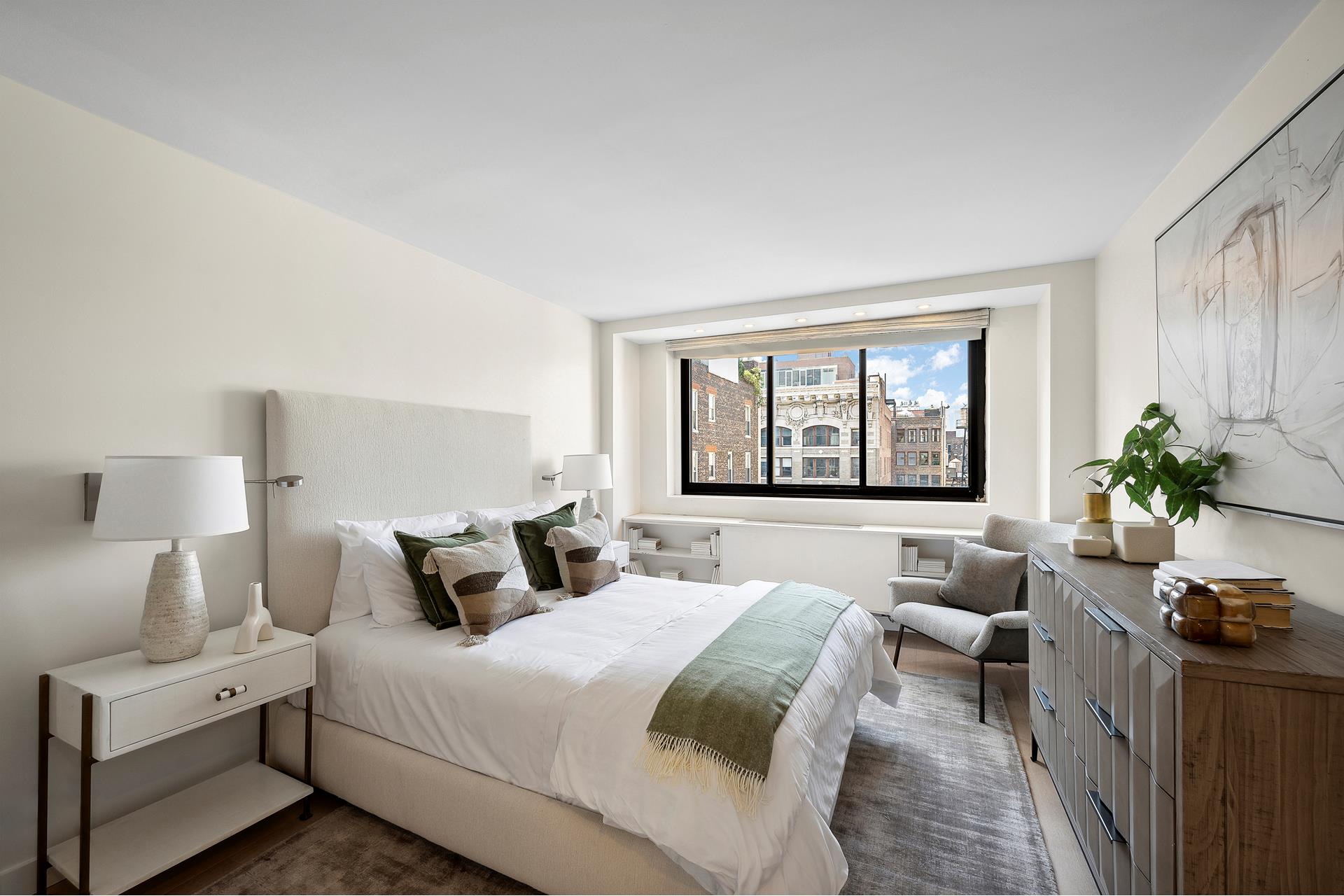 a bedroom with a bed and a large window