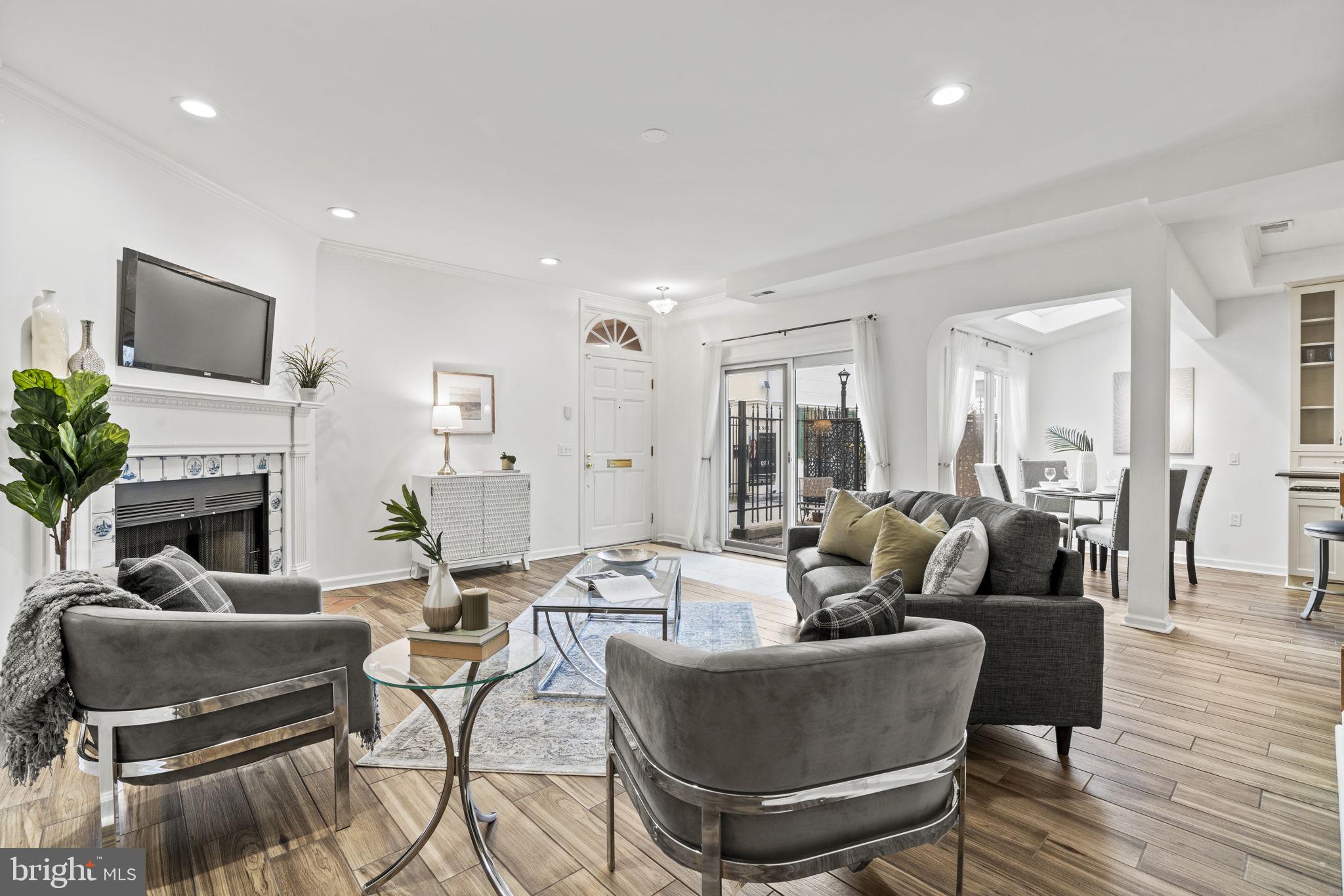 a living room with furniture a fireplace and a flat screen tv