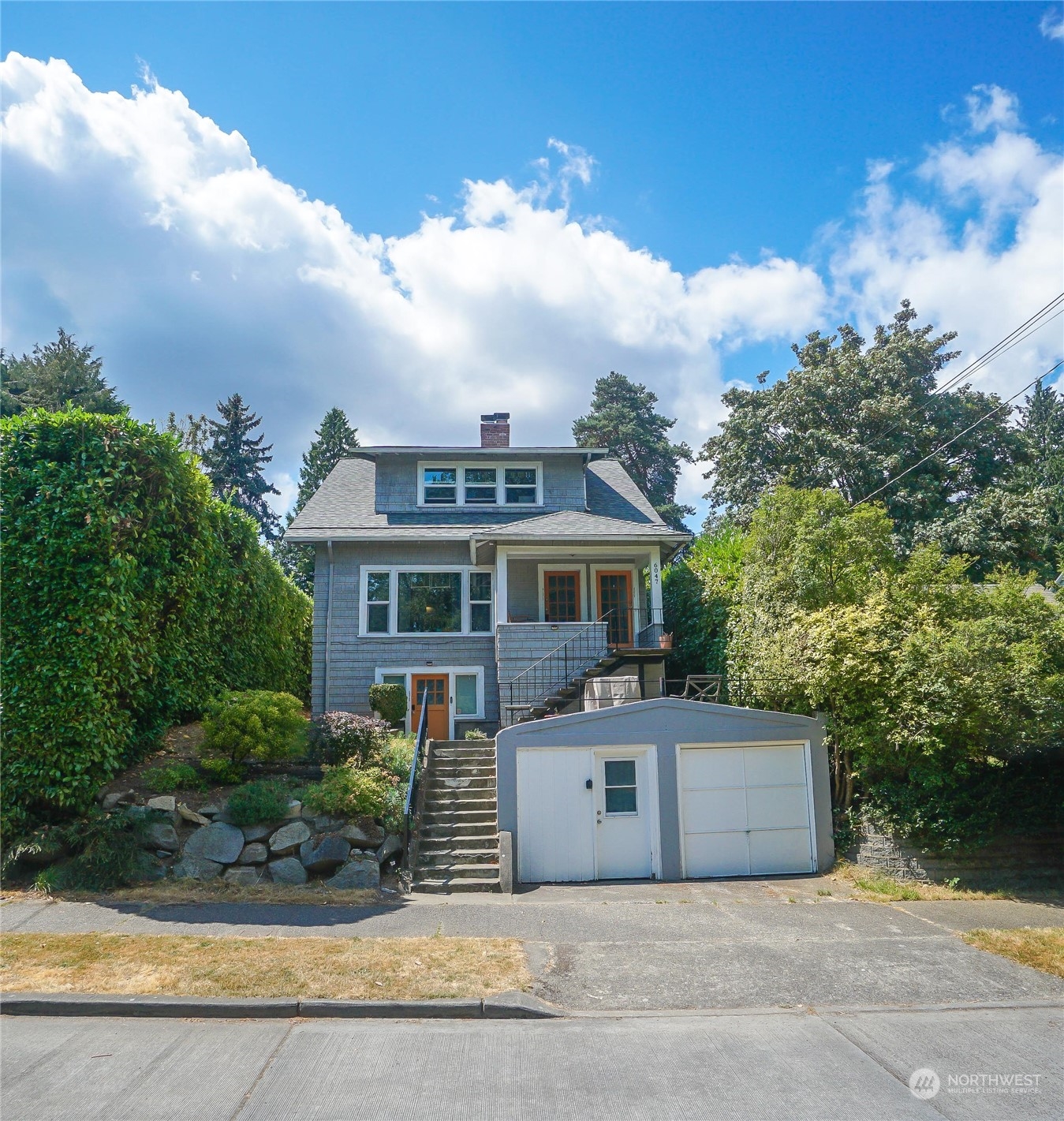 a front view of a house with a garden