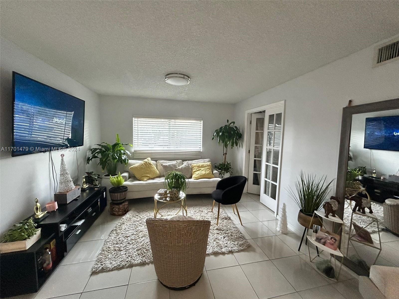 a living room with furniture potted plant and a window