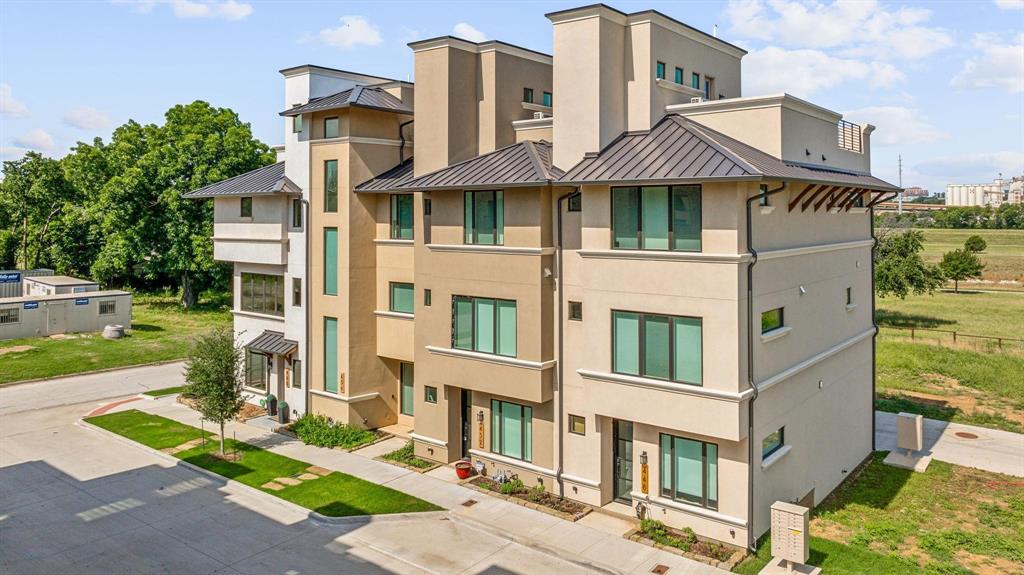 a front view of a residential apartment building with a yard