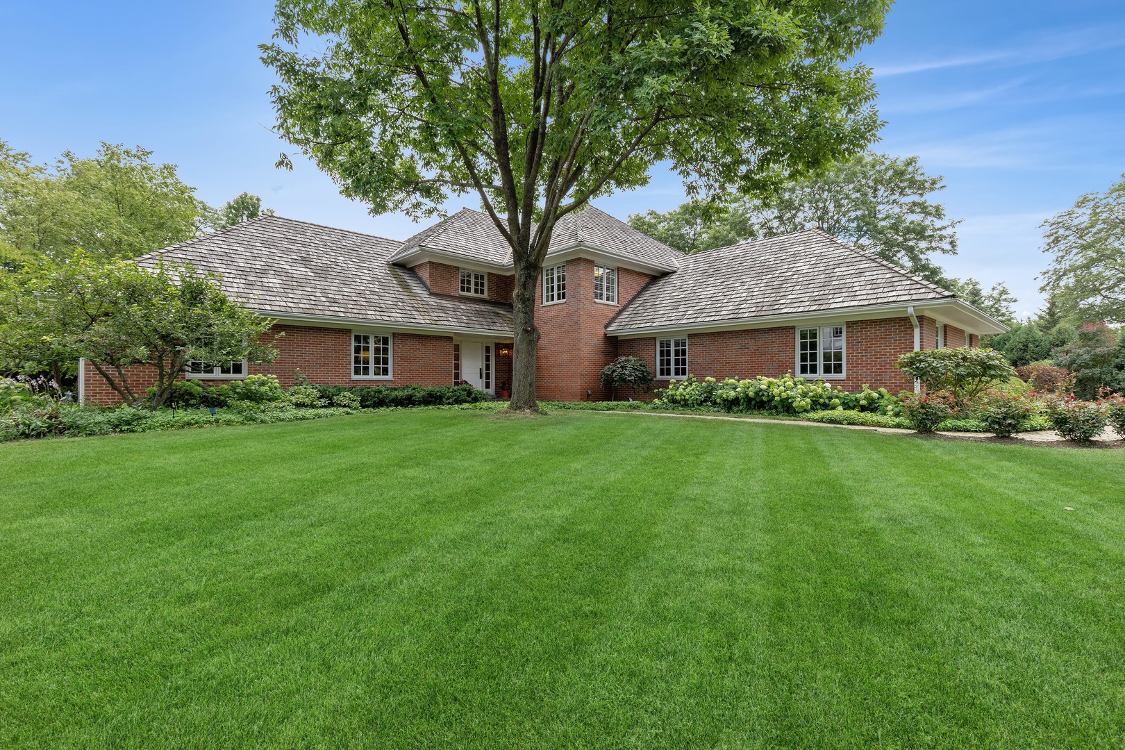 a front view of house with yard and green space