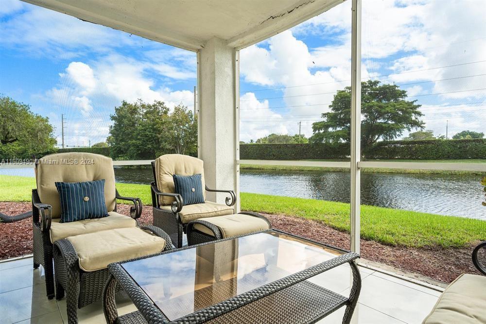 a front view of a house with lake view and a floor to ceiling window