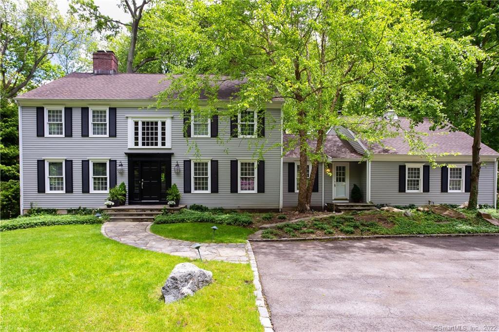 a front view of a house with a yard and porch