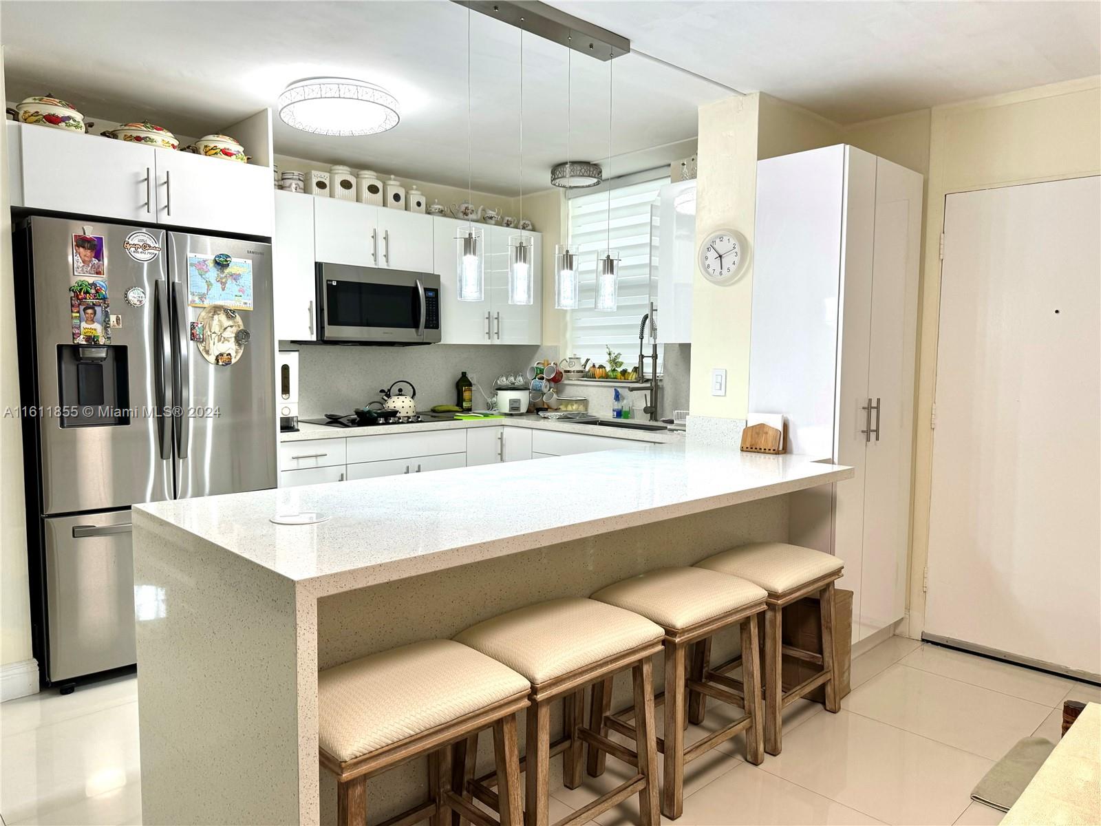 a kitchen with stainless steel appliances a sink and a refrigerator