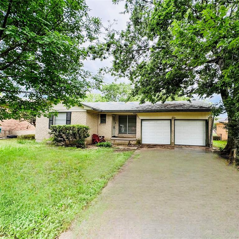 a view of a house with a yard and large trees