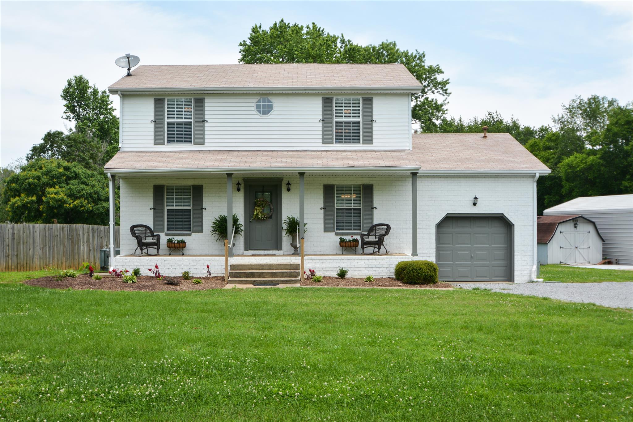 a front view of a house with garden and porch