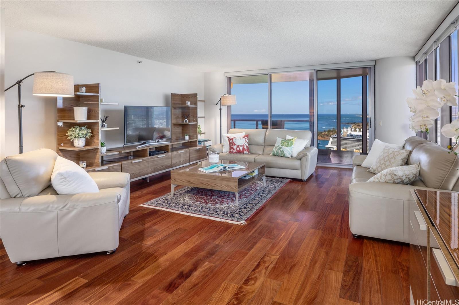 a living room with furniture and a wooden floor