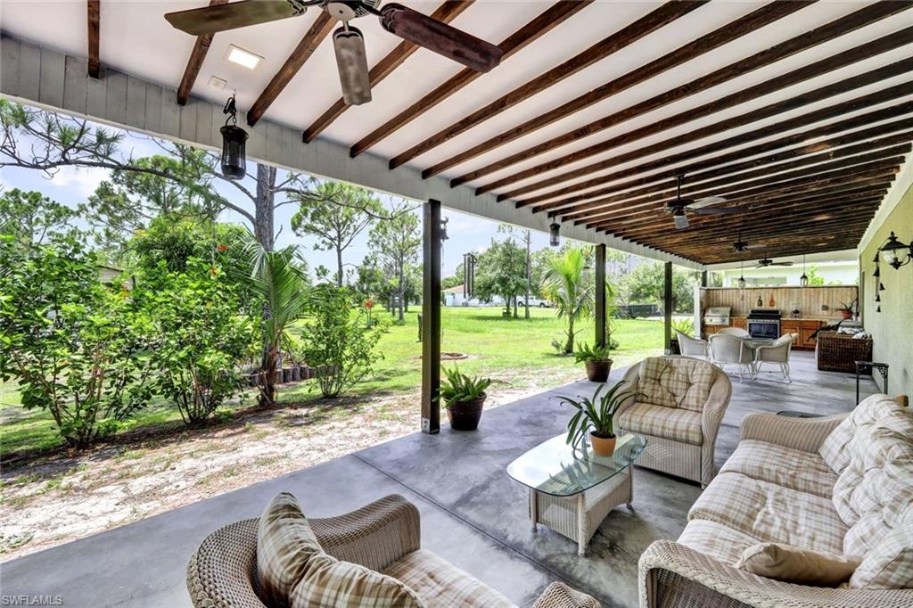 View of patio with ceiling fan and an outdoor hangout area