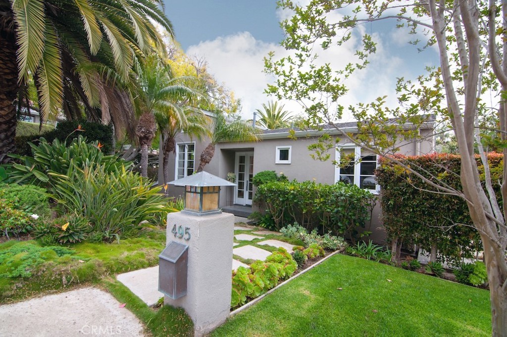 a front view of a house with garden