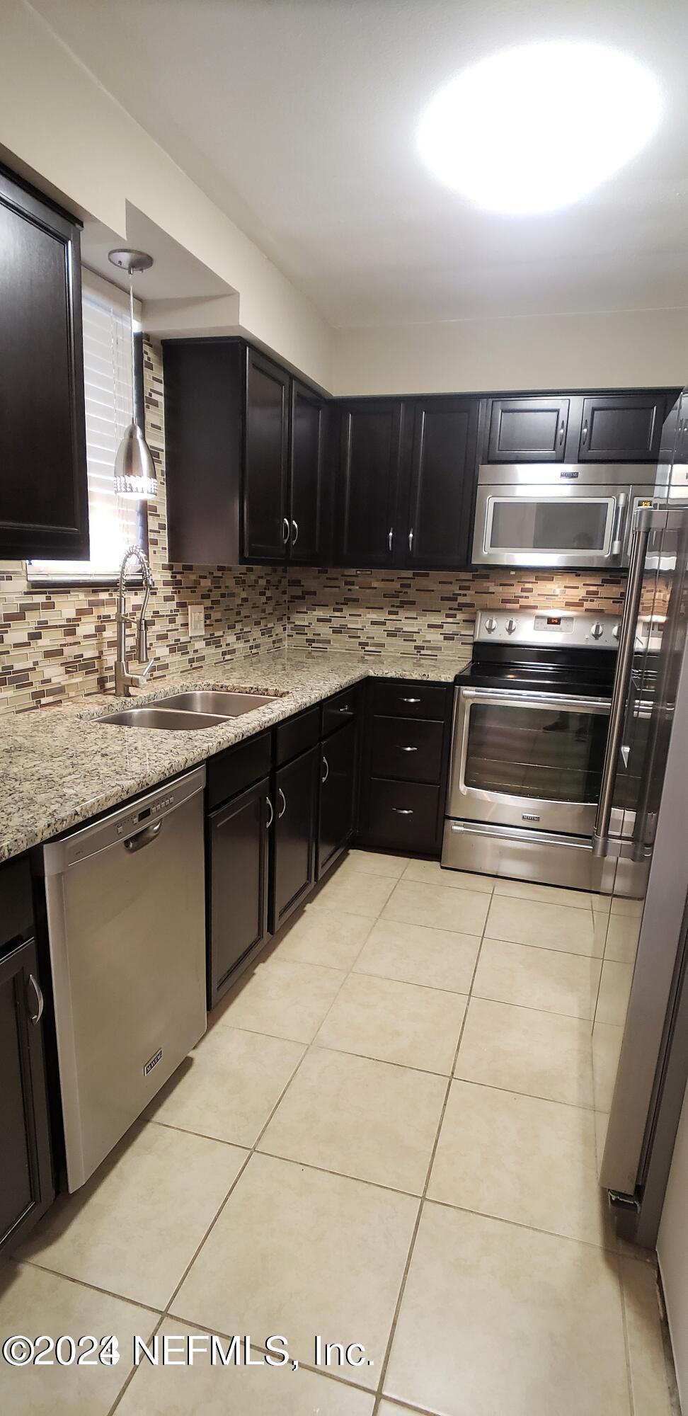 a kitchen with a stove and a sink