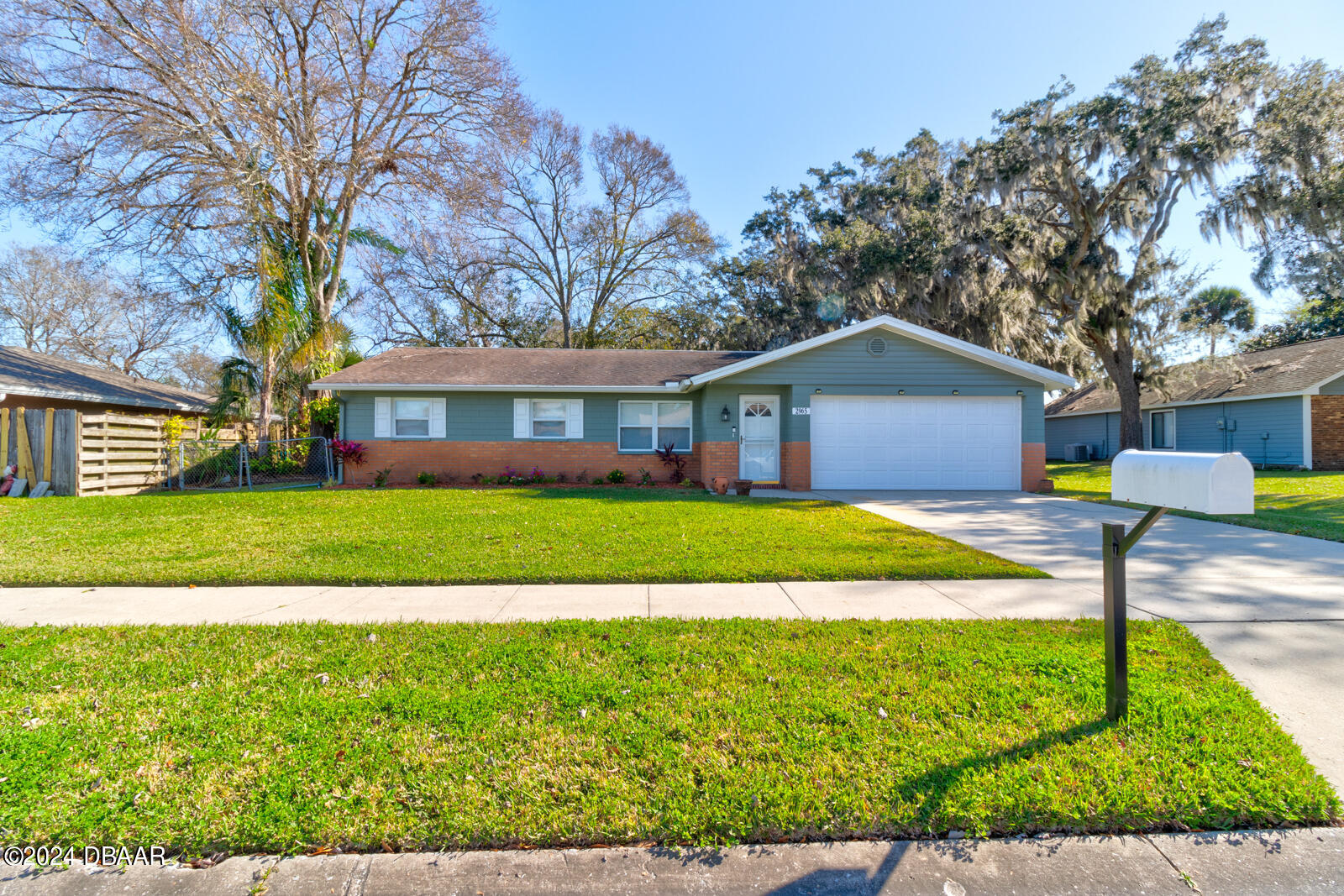 a front view of house with yard and green space