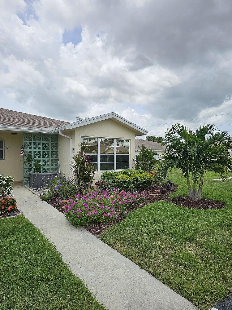 a front view of a house with a garden