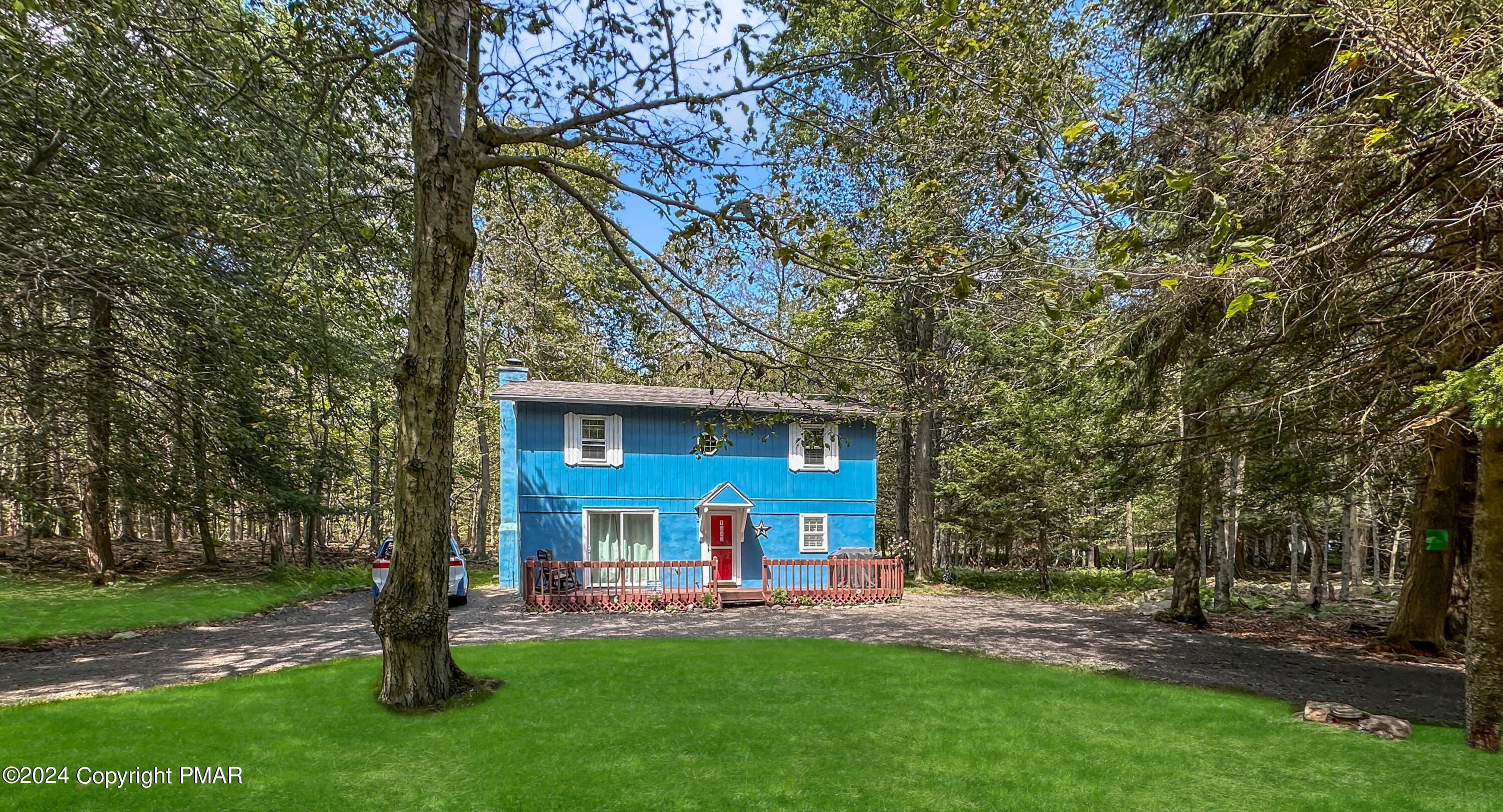 a view of a house with a yard porch and sitting area