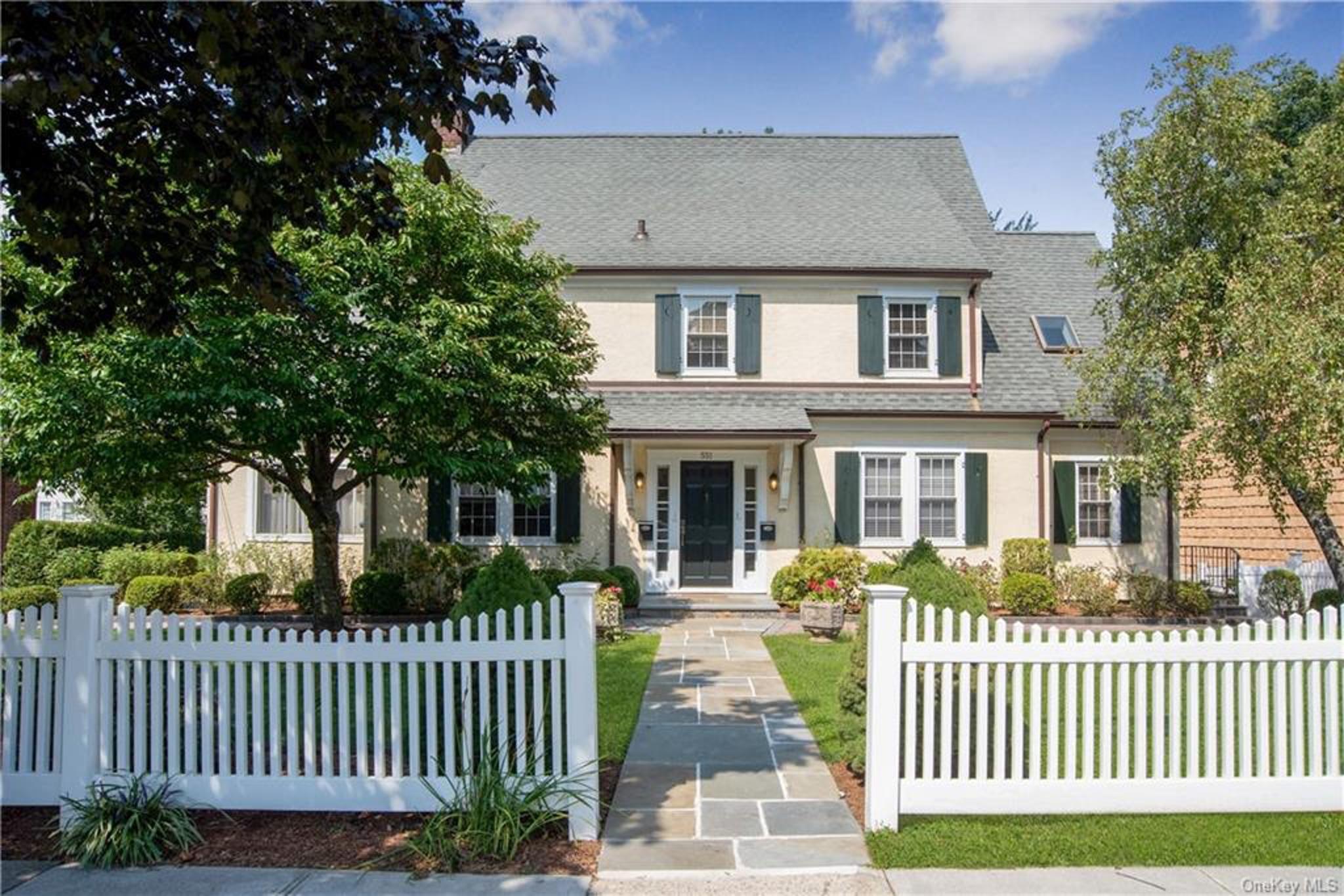 a front view of a house with a garden