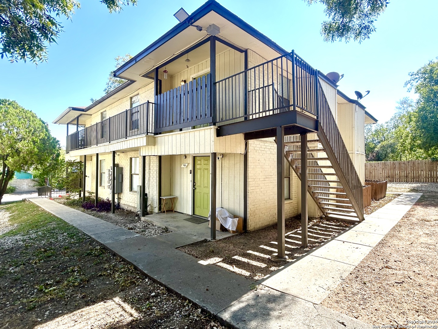 a view of a house with backyard and sitting area