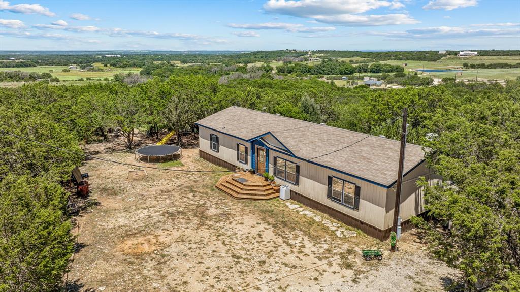 an aerial view of a house with garden space and ocean view