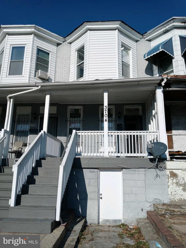 a view of a house with wooden fence and two windows