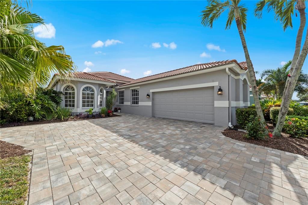 a front view of a house with a yard and a garage