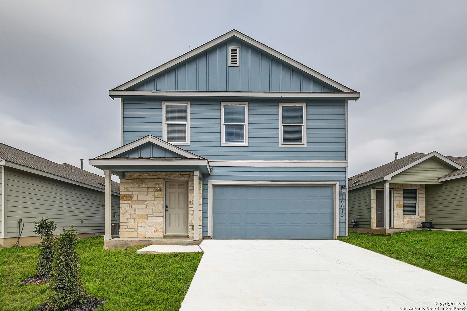 a front view of a house with a yard and garage