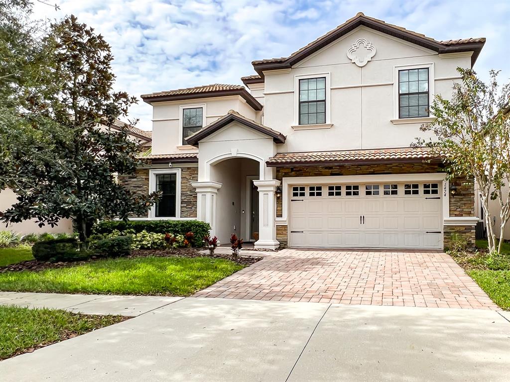 a front view of a house with a yard and garage