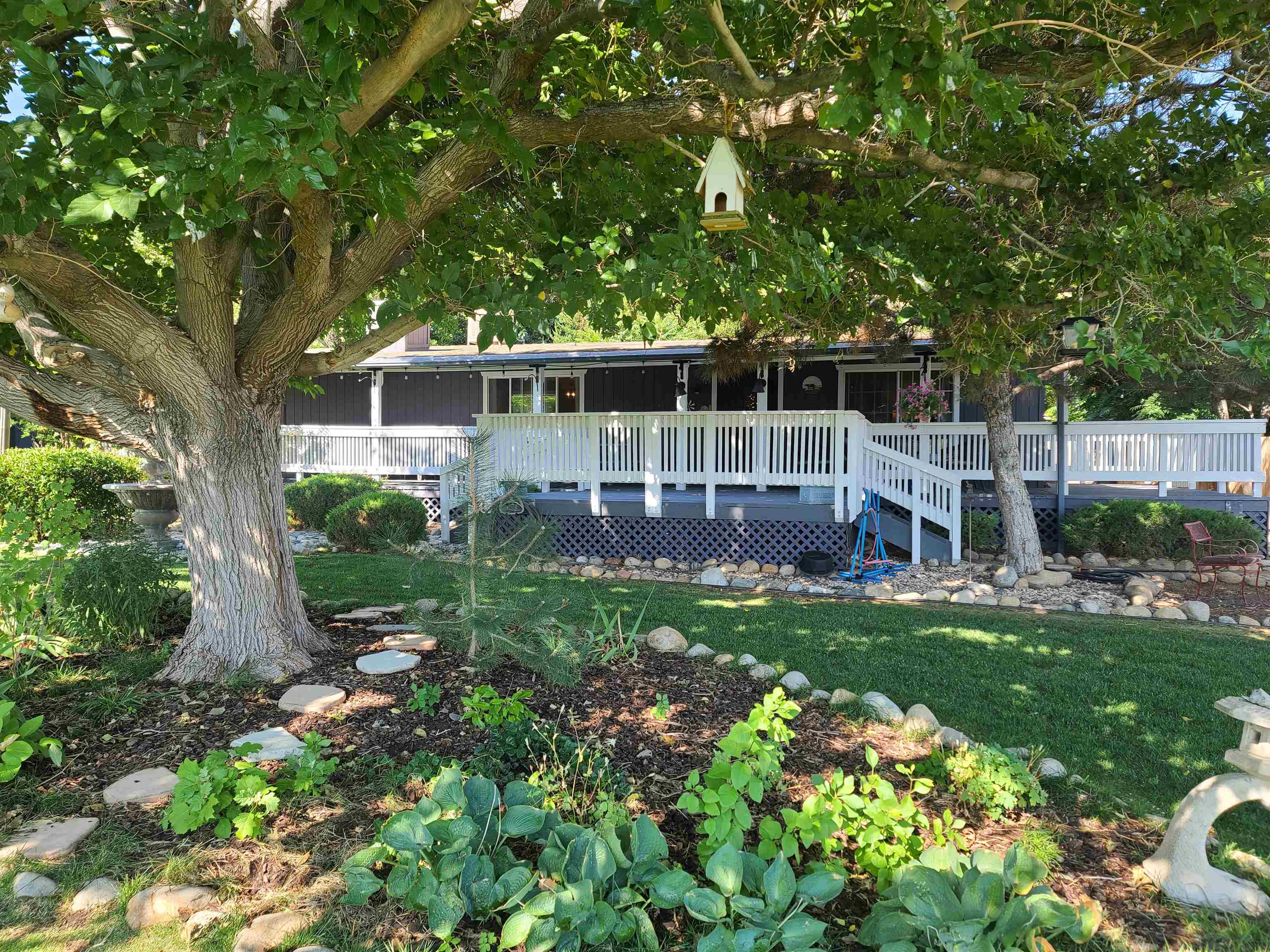 a view of a house with backyard and sitting area