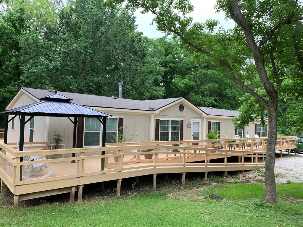 a view of a house with a backyard and porch