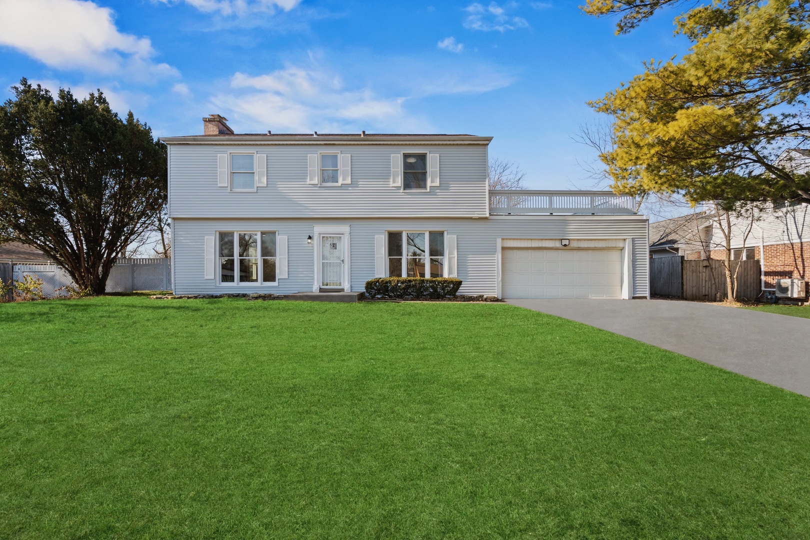 a front view of house with yard and green space