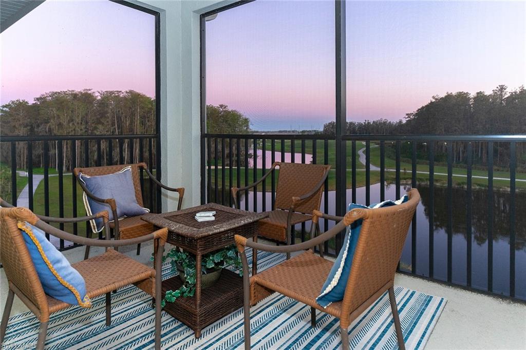 a view of a balcony with wooden floor and outdoor seating