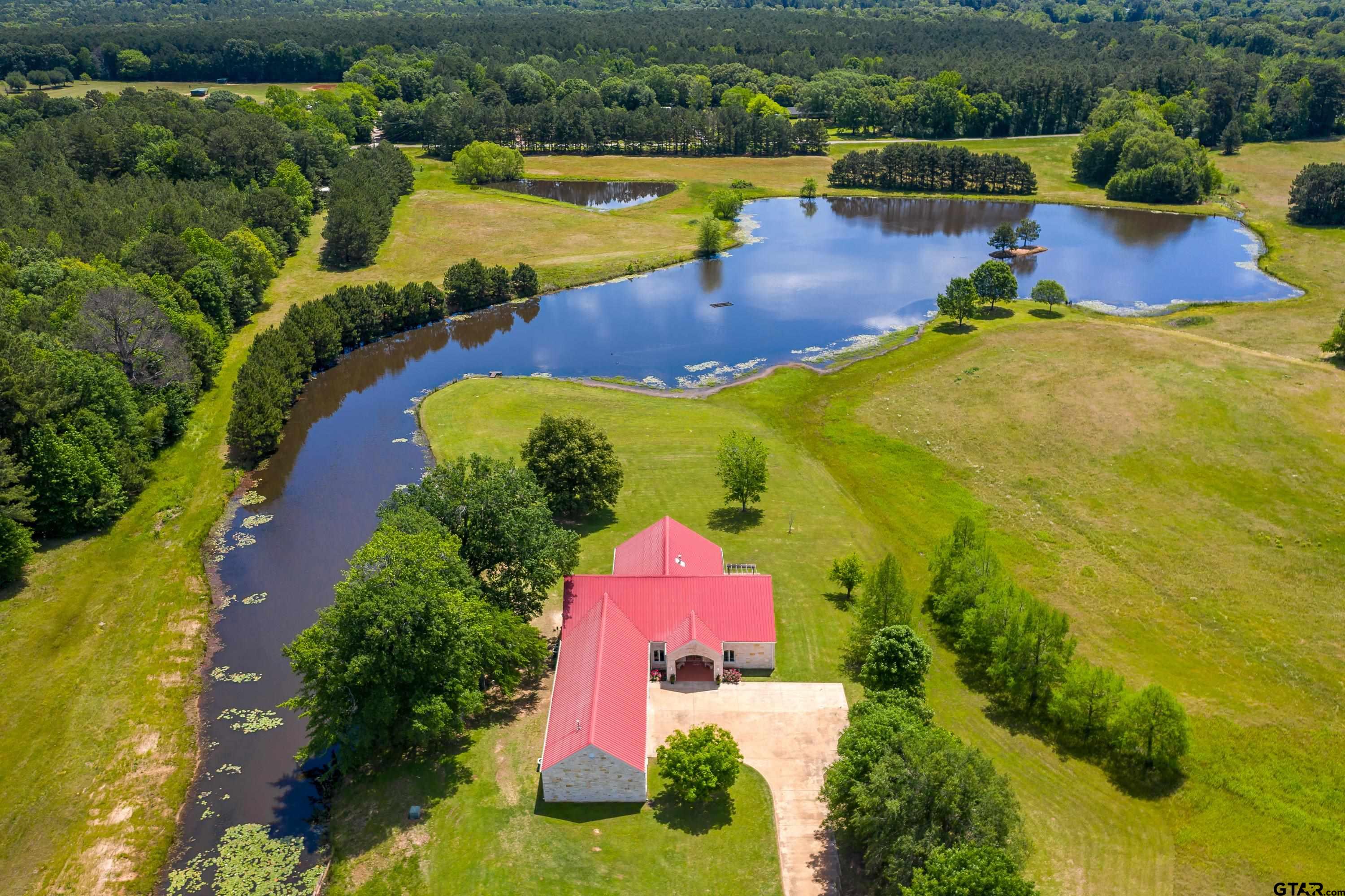 an aerial view of a house with swimming pool outdoor seating and yard