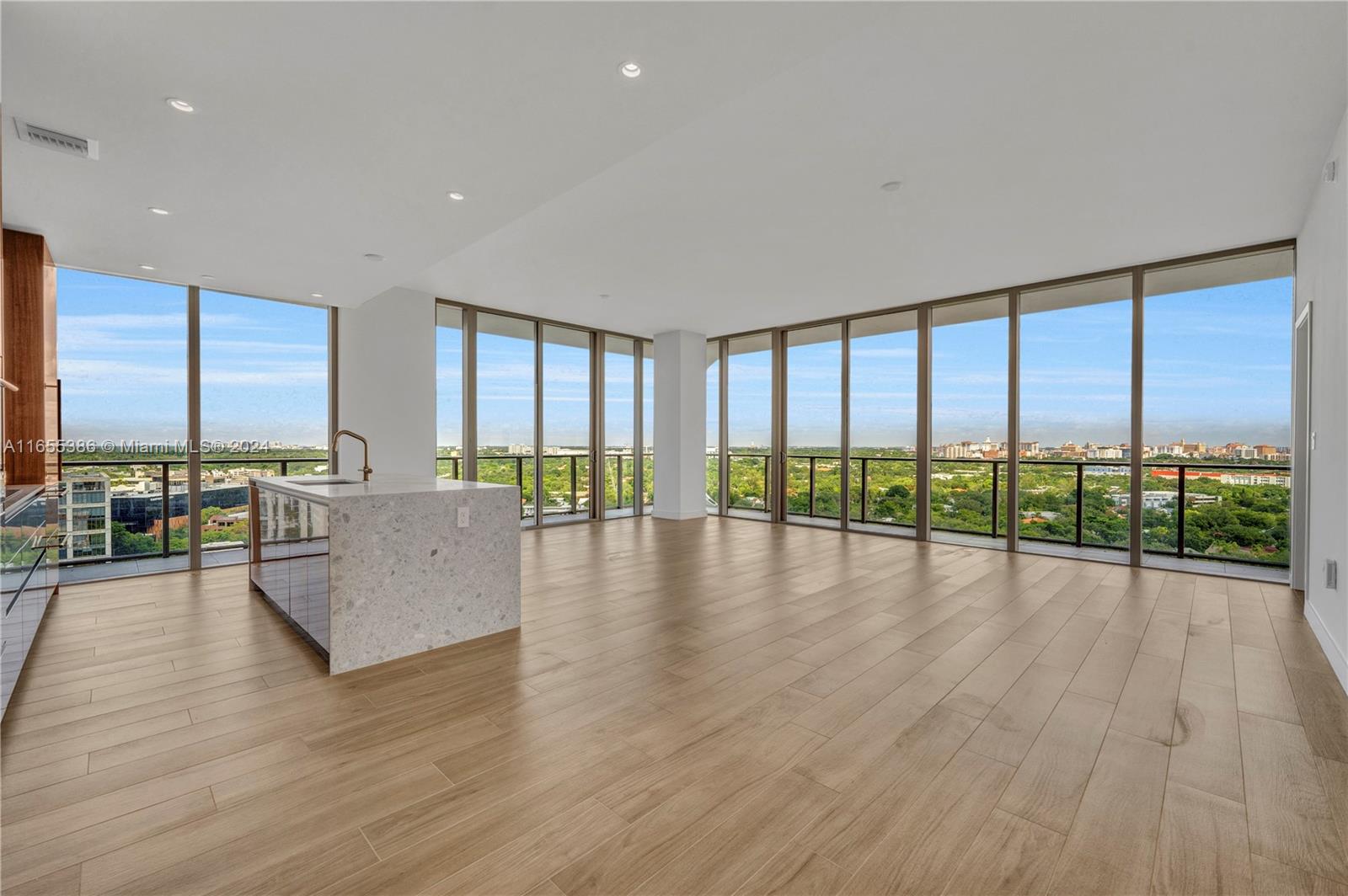 a view of empty room with wooden floor and windows