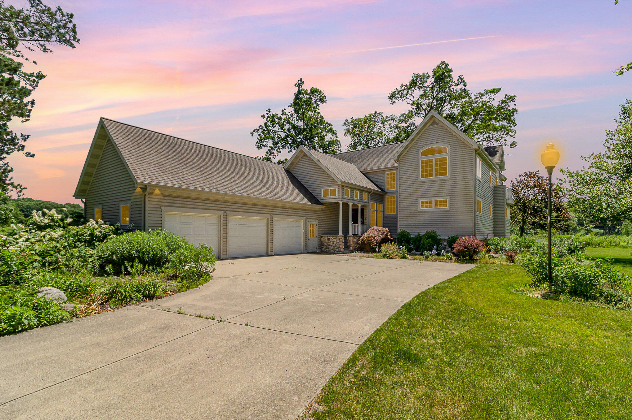 a front view of a house with a yard and garage