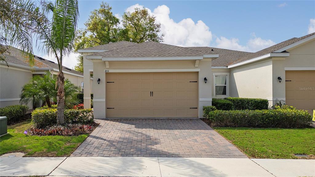 a front view of a house with a yard and garage