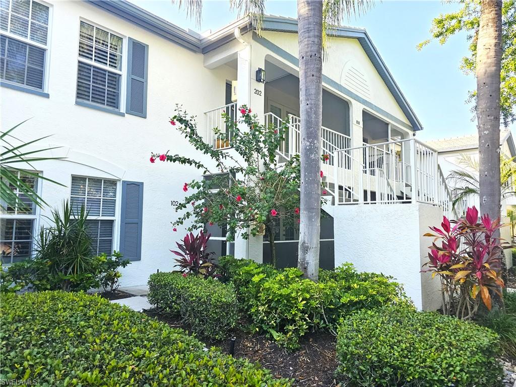 a front view of a house with a yard and flowers