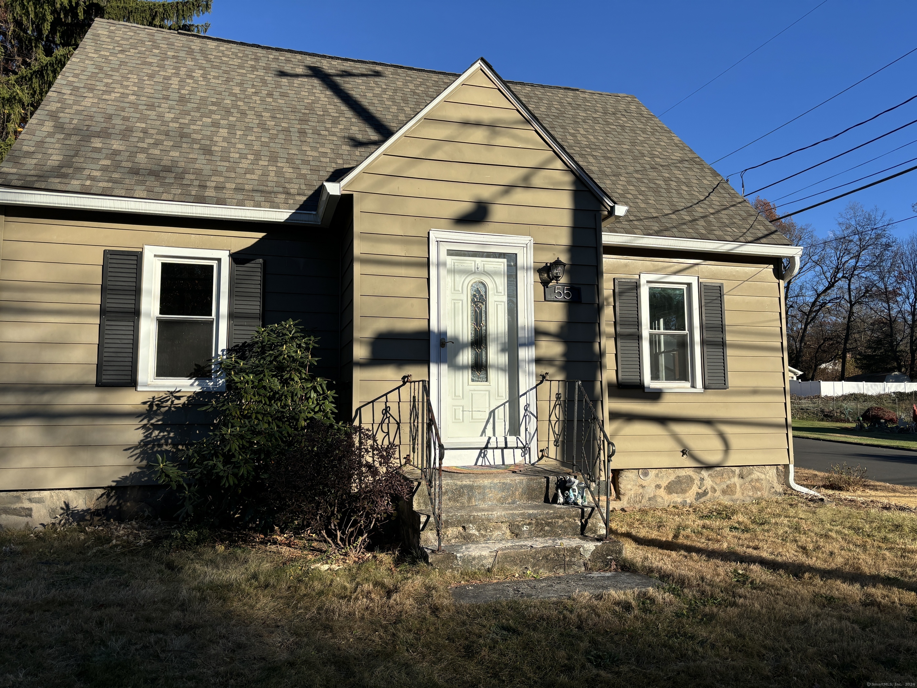 a view of house with backyard and sitting area