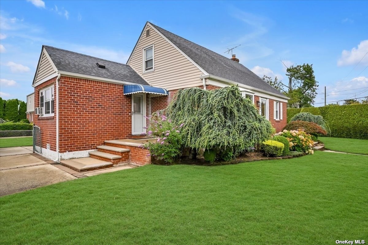 a front view of house with garden