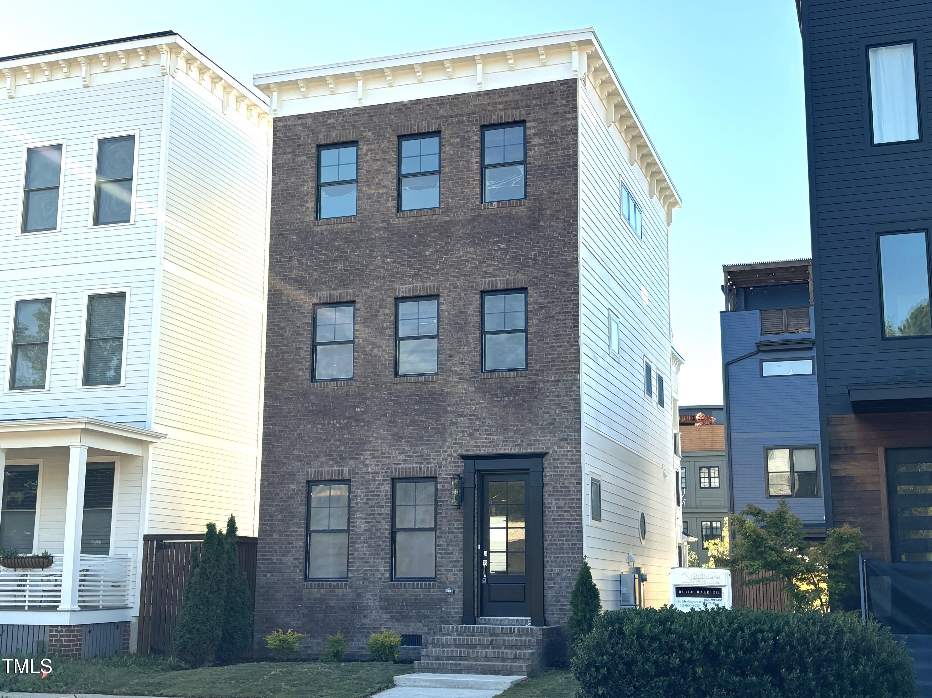 a front view of a building with garden