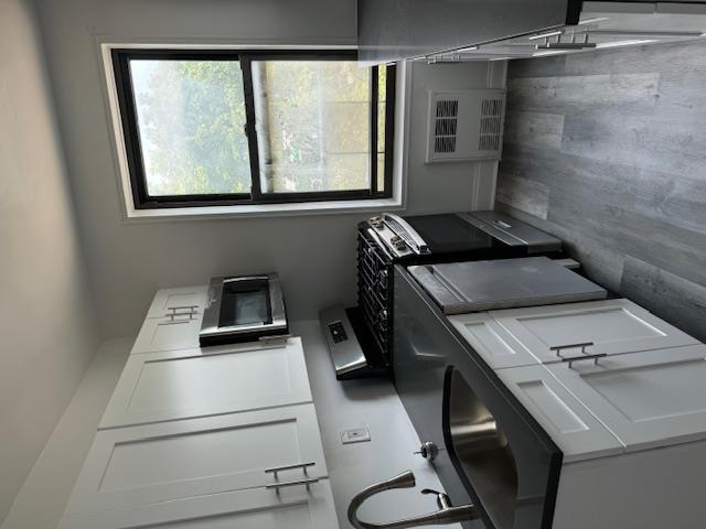 a kitchen with a sink a stove and microwave