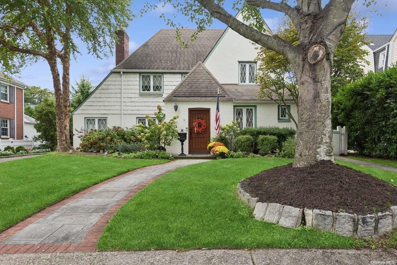 a view of a house with a yard and potted plants