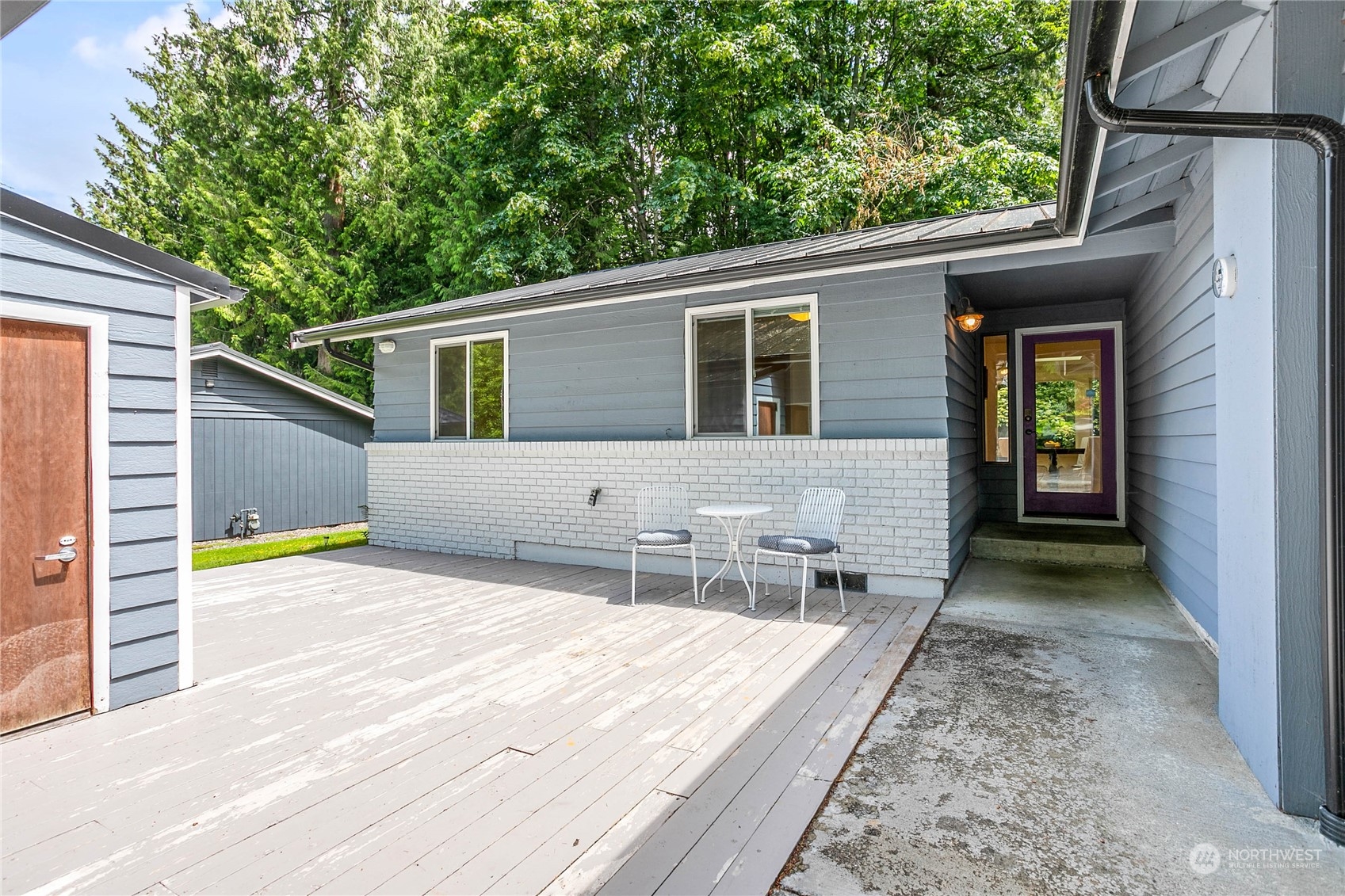 a backyard of a house with yard and outdoor seating