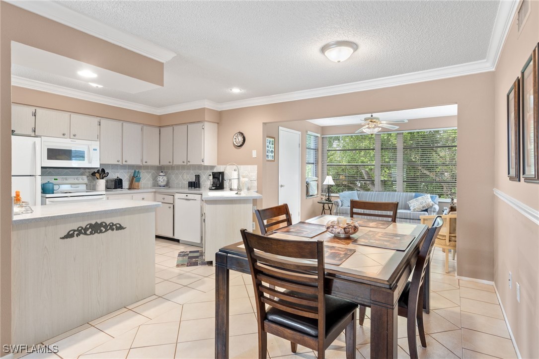 a kitchen with a table chairs and a refrigerator