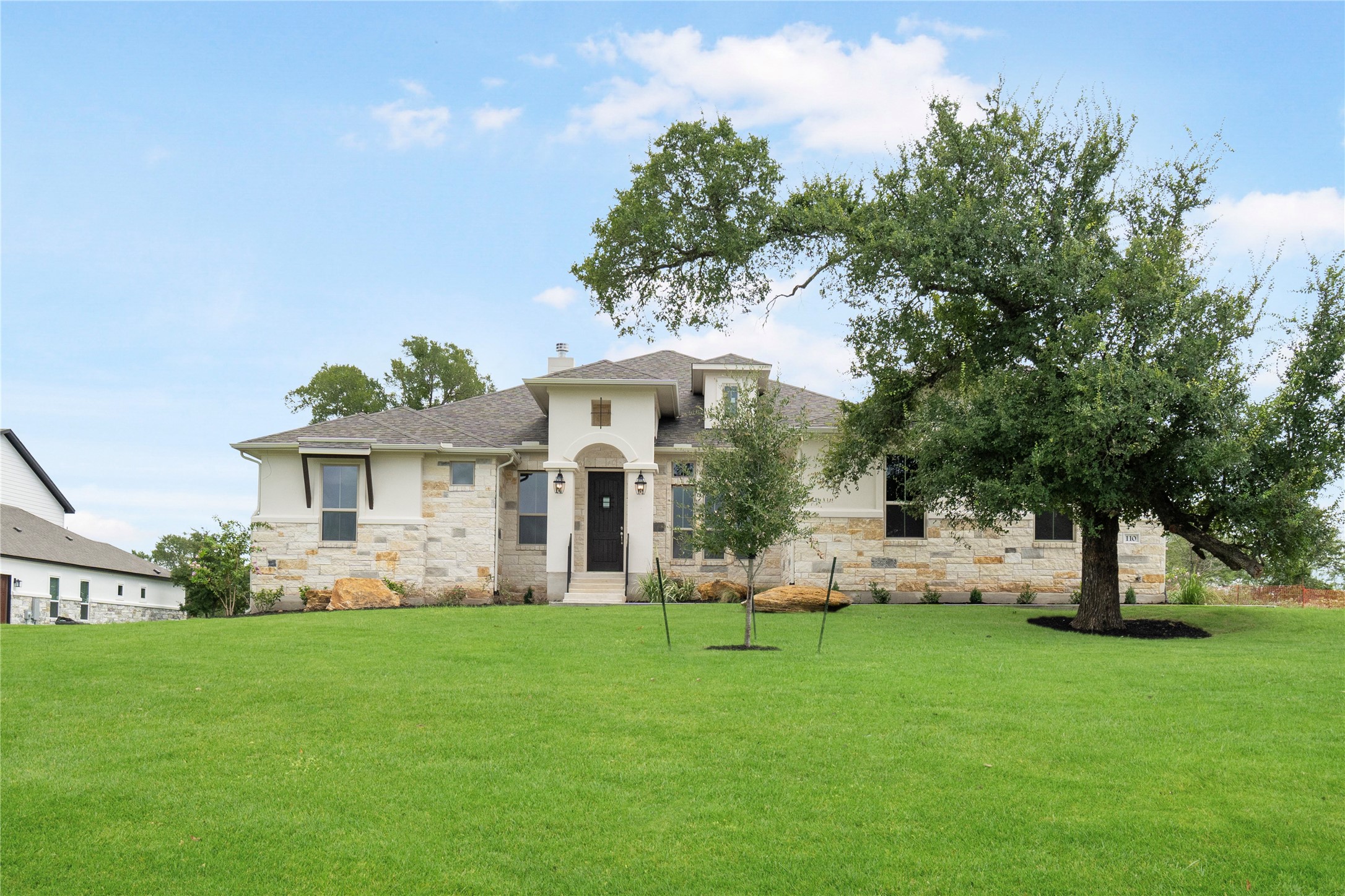 a front view of house with yard and green space