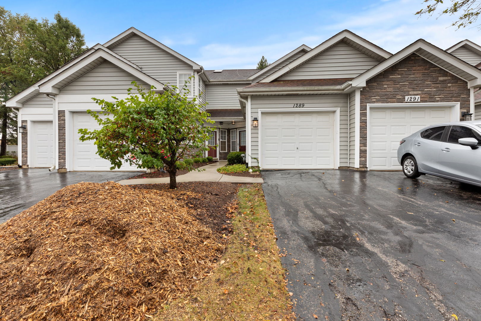 a view of a house with a yard and garage