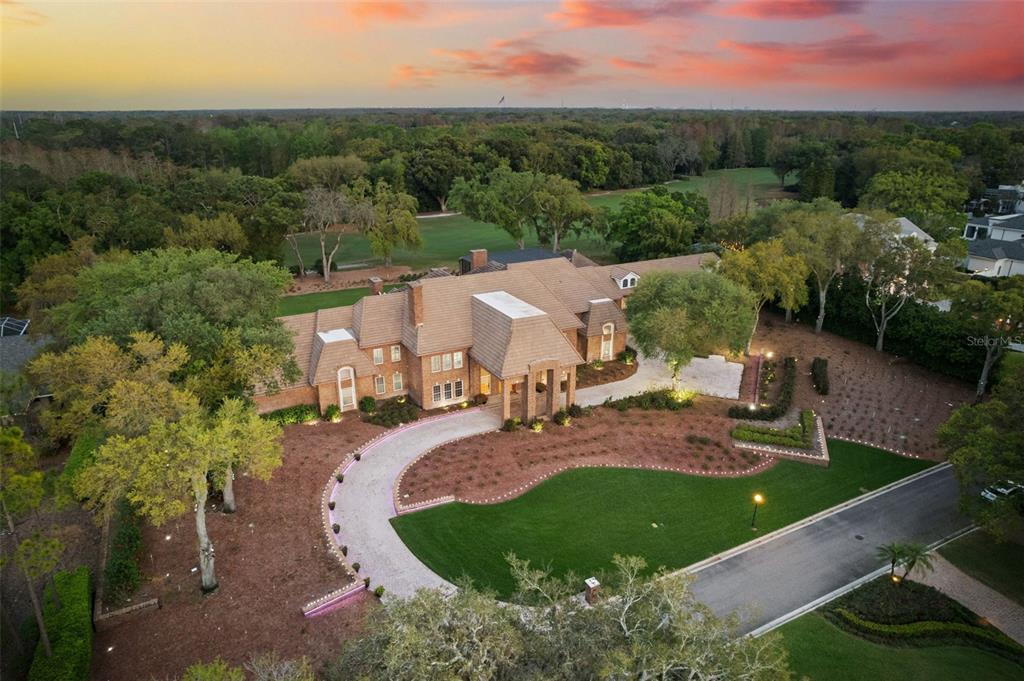 an aerial view of a house with garden space and street view