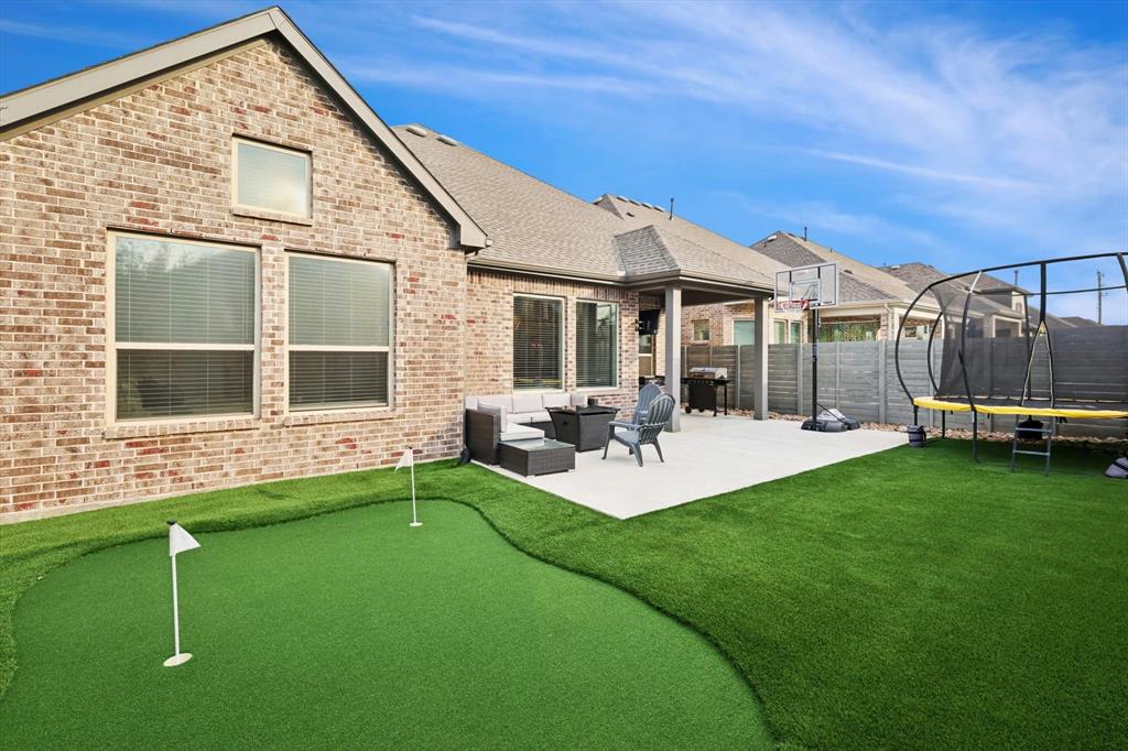 a front view of a house with backyard and sitting area