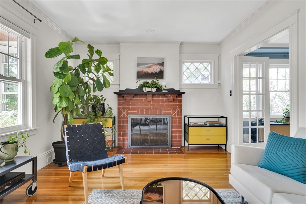 a living room with furniture a window and a fireplace