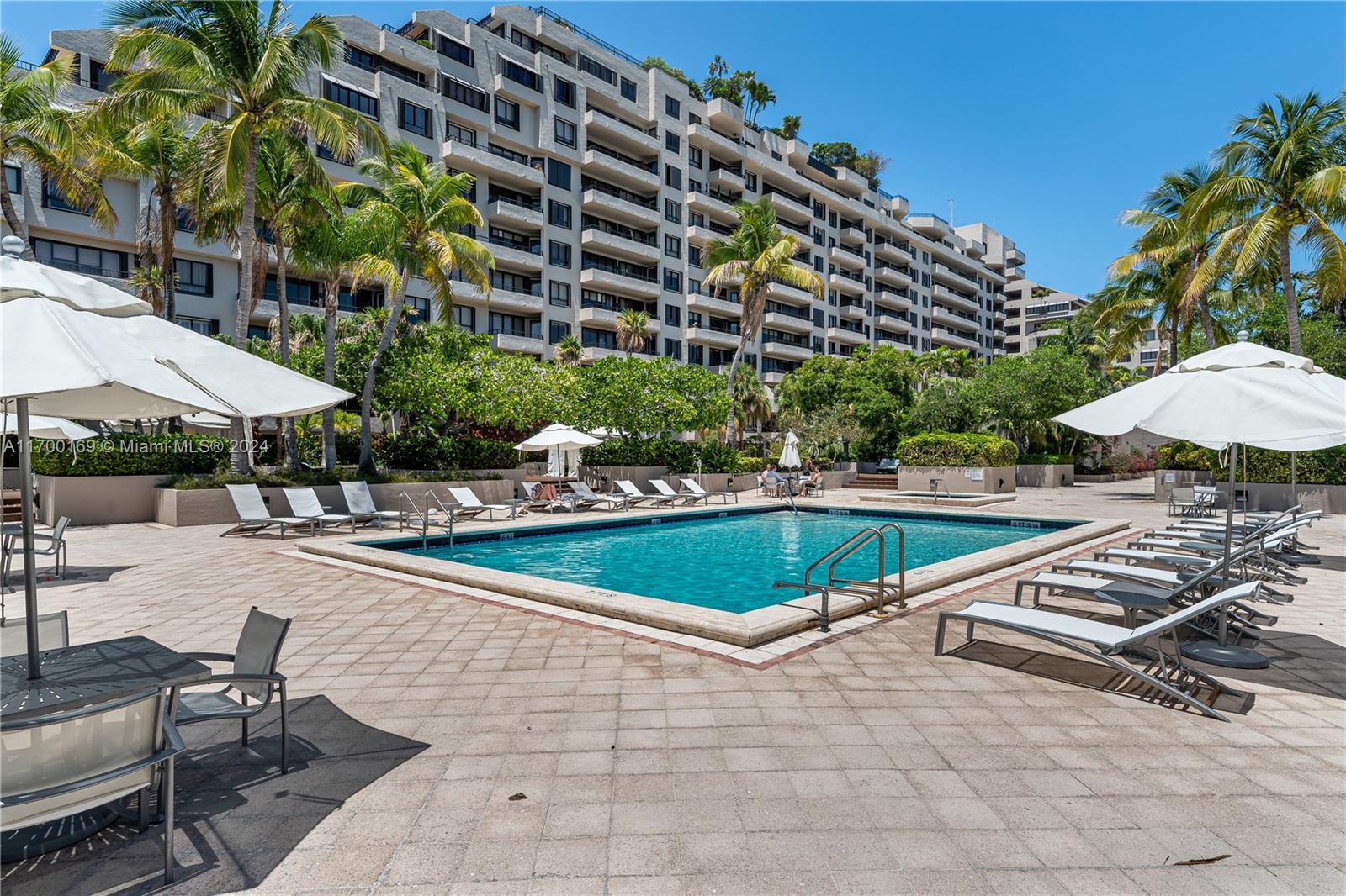 a view of a swimming pool and lounge chairs