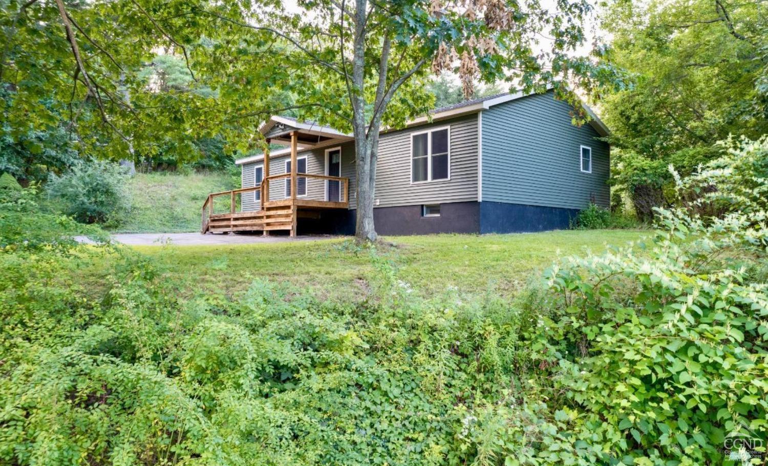 a view of a house with backyard and sitting area